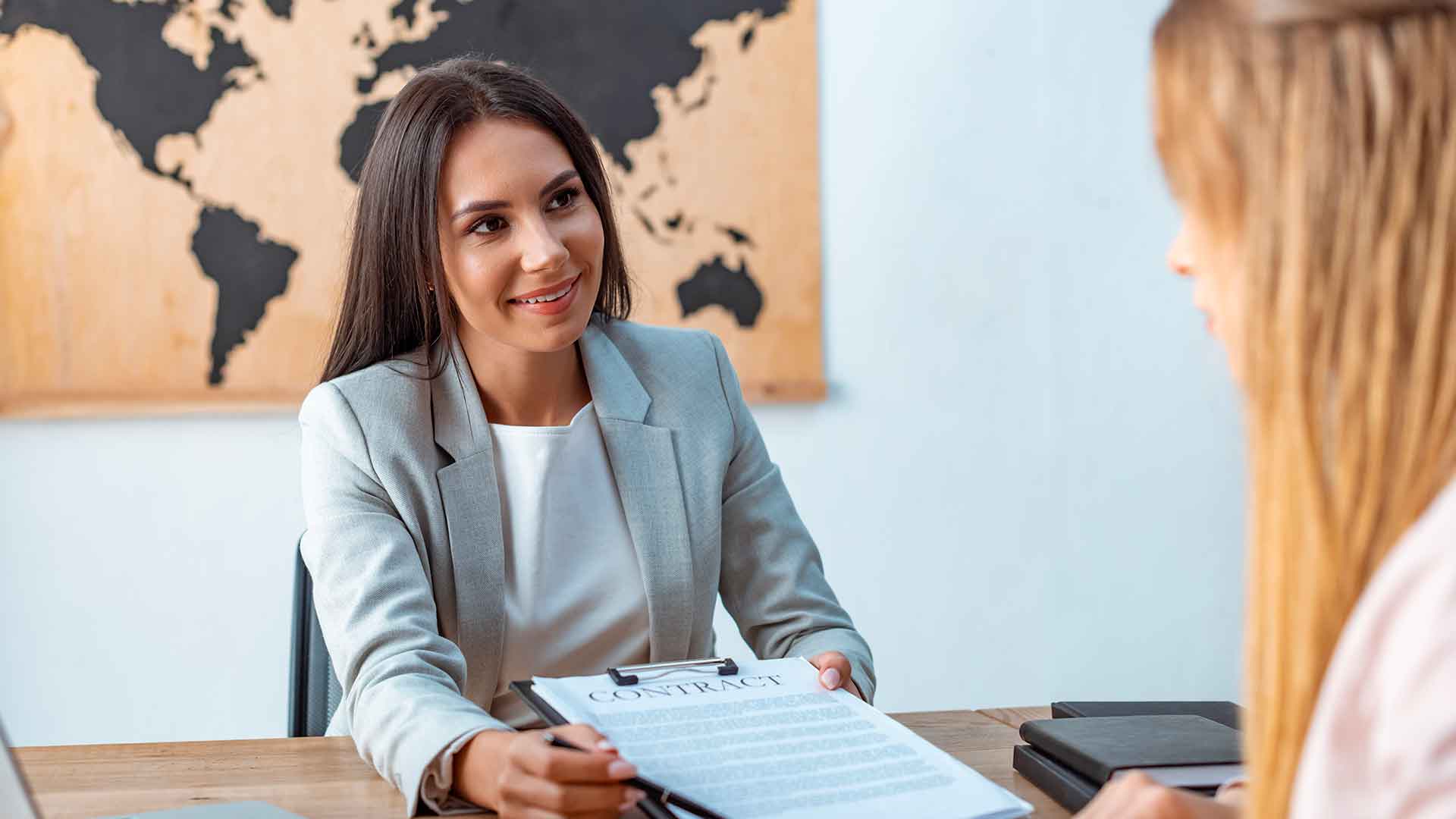 Employée d'une compagnie d'assurance pour voyageurs présentant un contrat à une cliente